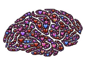 A drawing of a brain with a bunch of heart emojis in it.