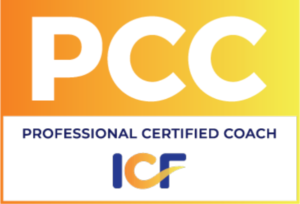 Rectangular badge logo with bright orange and yellow background. White lettering state: "PCC Professional Certified Coach."