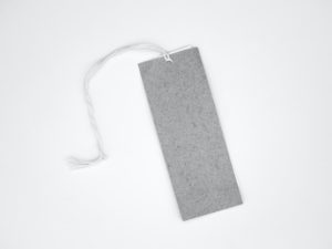 Grey label tag laid flat on a white background.