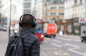 Person wearing headphones near a crosswalk.