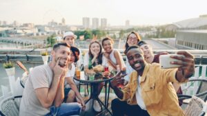 A group of friends taking a picture together on a rooftop.