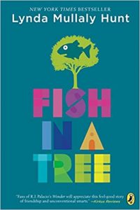A book cover. Green background with the words "New York Times Bestseller, Lynda Mullaly Hunt" at the top and in the middle it writes "Fish In A Tree", with a drawing of a fish in a tree above it.