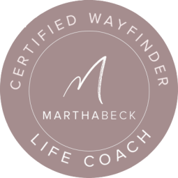 A reddish brown circle with the words "Certified Wayfinder" written on a curve at the top, "Life Coach" written on a curve at the bottom, and "Marthabeck" written in the middle with a M above it.